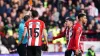 Mason Holgate is shown a red card by referee Stuart Attwell (Nick Potts/PA)