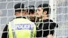 Police speak to a protester who chained themselves to a goalpost (Jane Barlow/PA)