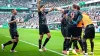 Harry Kane is congratulated by team-mates after scoring for Bayern Munich against Werder Bremen (Sina Schuldt/dpa via AP)