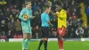 Watford’s Edo Kayembe, right, and Portsmouth goalkeeper Nicolas Schmid are booked by referee Geoff Eltringham, centre (Yui M