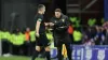 Referee Don Robertson (left) passes an object that was thrown from the crowd towards Celtic’s Arne Engels (Steve Welsh/PA)